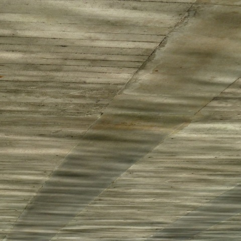 t00456: semi-abstract photo (reflections on underside of bridge) by Ewart Shaw