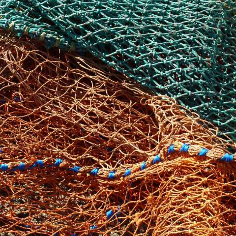 t00782: semi-abstract photo (fishing nets on quayside) by Ewart Shaw